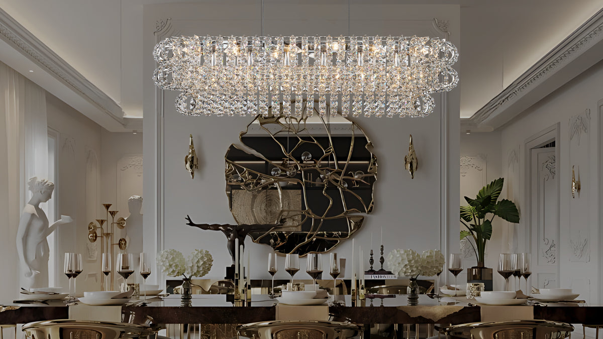 Amulette Oval 3 Tier Chandelier above a styled dining table in a warm modern room — DecorLane